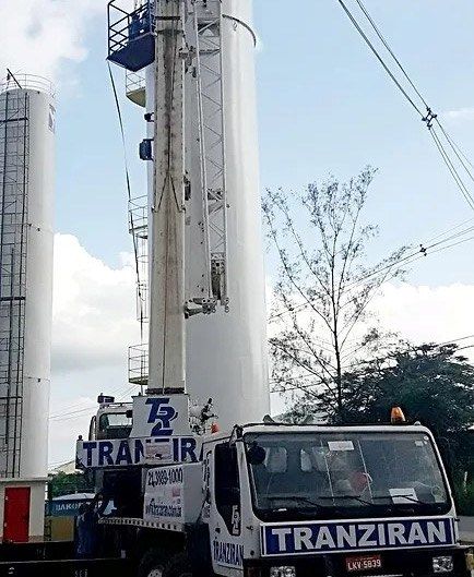 Guindaste içando tanque industrial na posição vertical